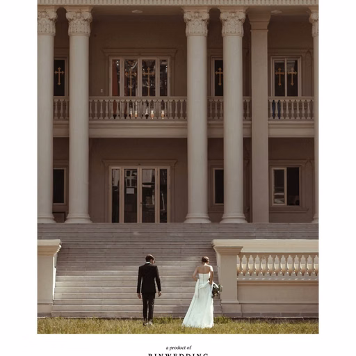 The couple stands in the distance before the façade of Nhà thờ Don Bosco