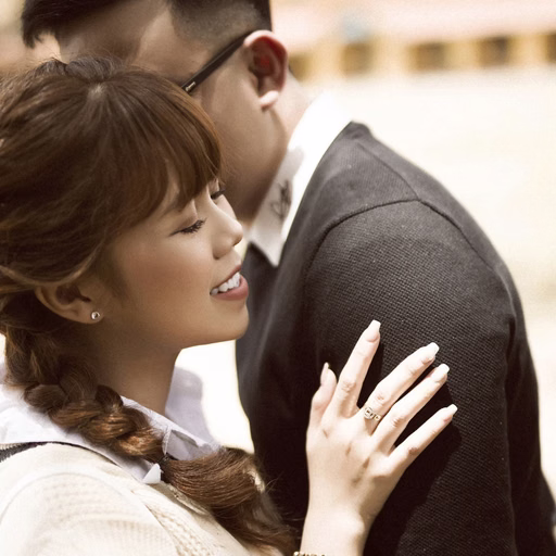 Close-up of the couple embracing before Cao Đẳng Sư Phạm Đà Lạt.