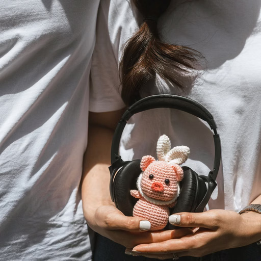 Details of the couple's hands, a small bag and a rabbit keychain in a Đà Lạt café photoshoot.