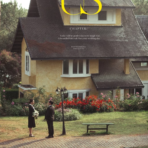 The couple before a steep-roofed villa, with decorative lettering on the wedding photograph.