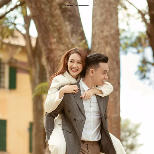 The groom carrying the laughing bride on his back before Dinh Tỉnh Trưởng.