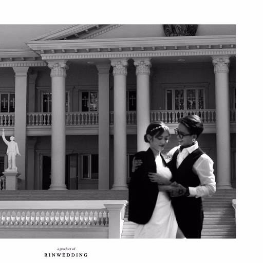 Black-and-white photograph of the couple before the columns of Nhà thờ Don Bosco