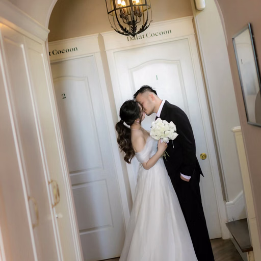 A couple kisses beneath hanging lights in a corridor at The Nest, Đà Lạt
