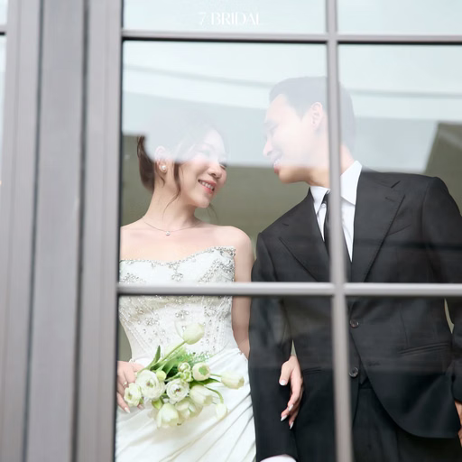 The couple looks at each other through a resort's glass window.