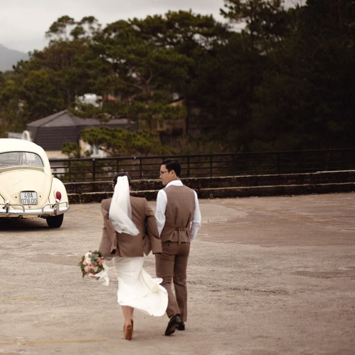 The couple walks toward a cream vintage car in the Cáp Treo Đà Lạt area.