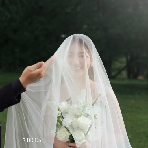The groom lifts the bride's veil before pine trees at Cây Thông Cô Đơn, Đà Lạt
