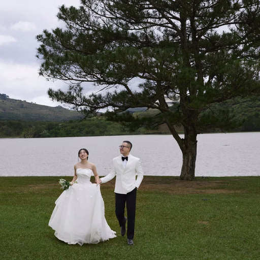 The couple walk hand in hand on the grass before the pine at Cây Thông Cô Đơn, Đà Lạt
