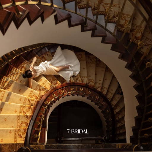 Overhead view of the couple on a spiral staircase.
