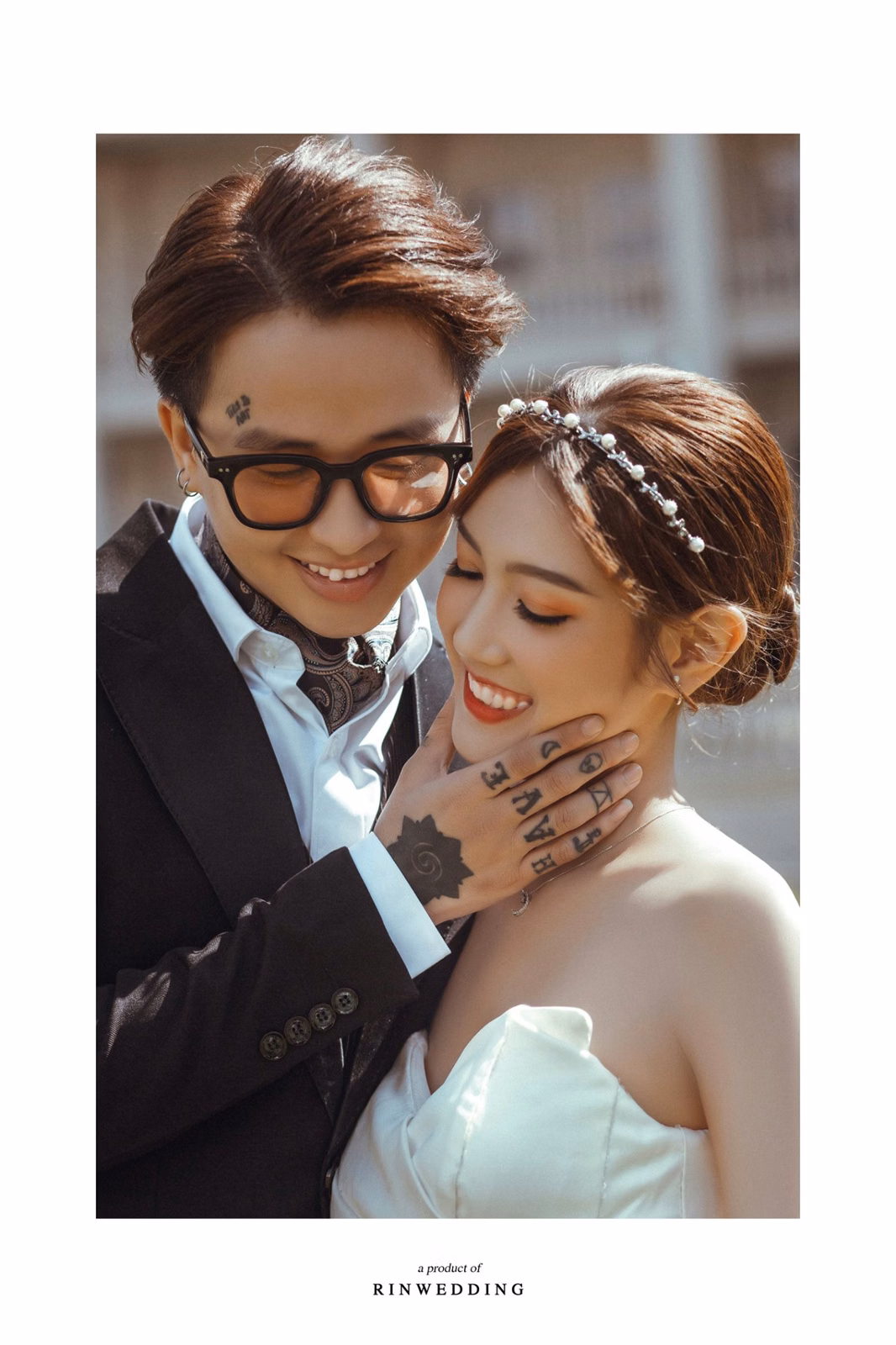 The couple leans close together at Nhà thờ Don Bosco