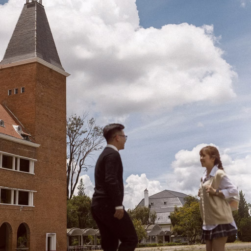 The couple before the bell tower at Cao Đẳng Sư Phạm Đà Lạt.
