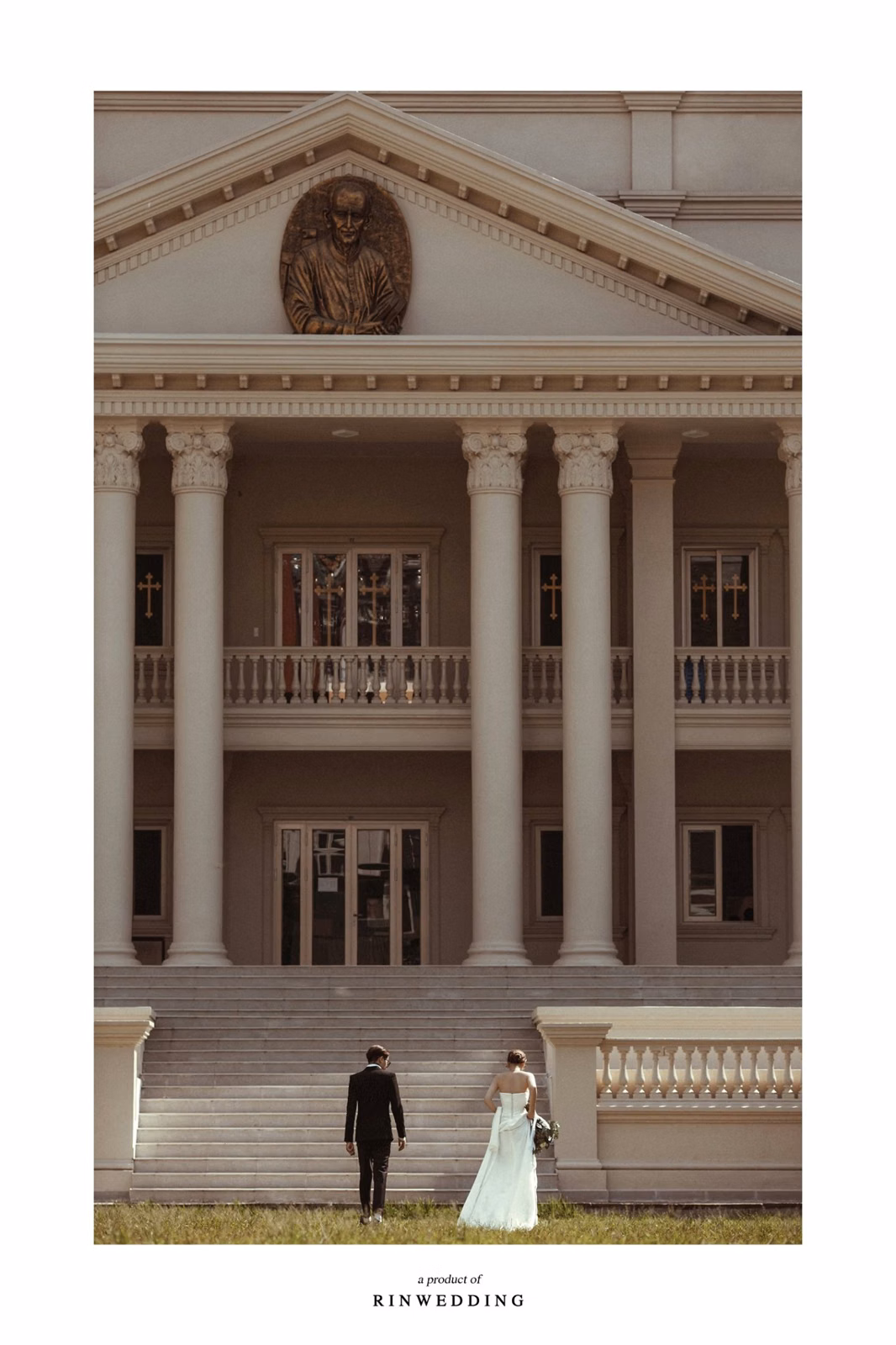 The couple stands in the distance before the façade of Nhà thờ Don Bosco