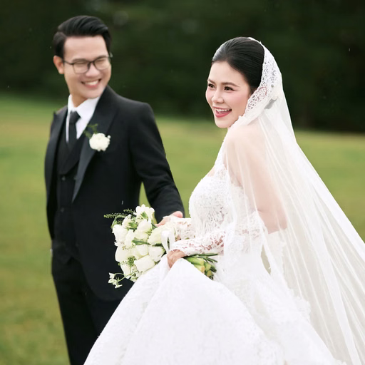 The bride and groom smile together on the grass at Cây Thông Cô Đơn, Đà Lạt