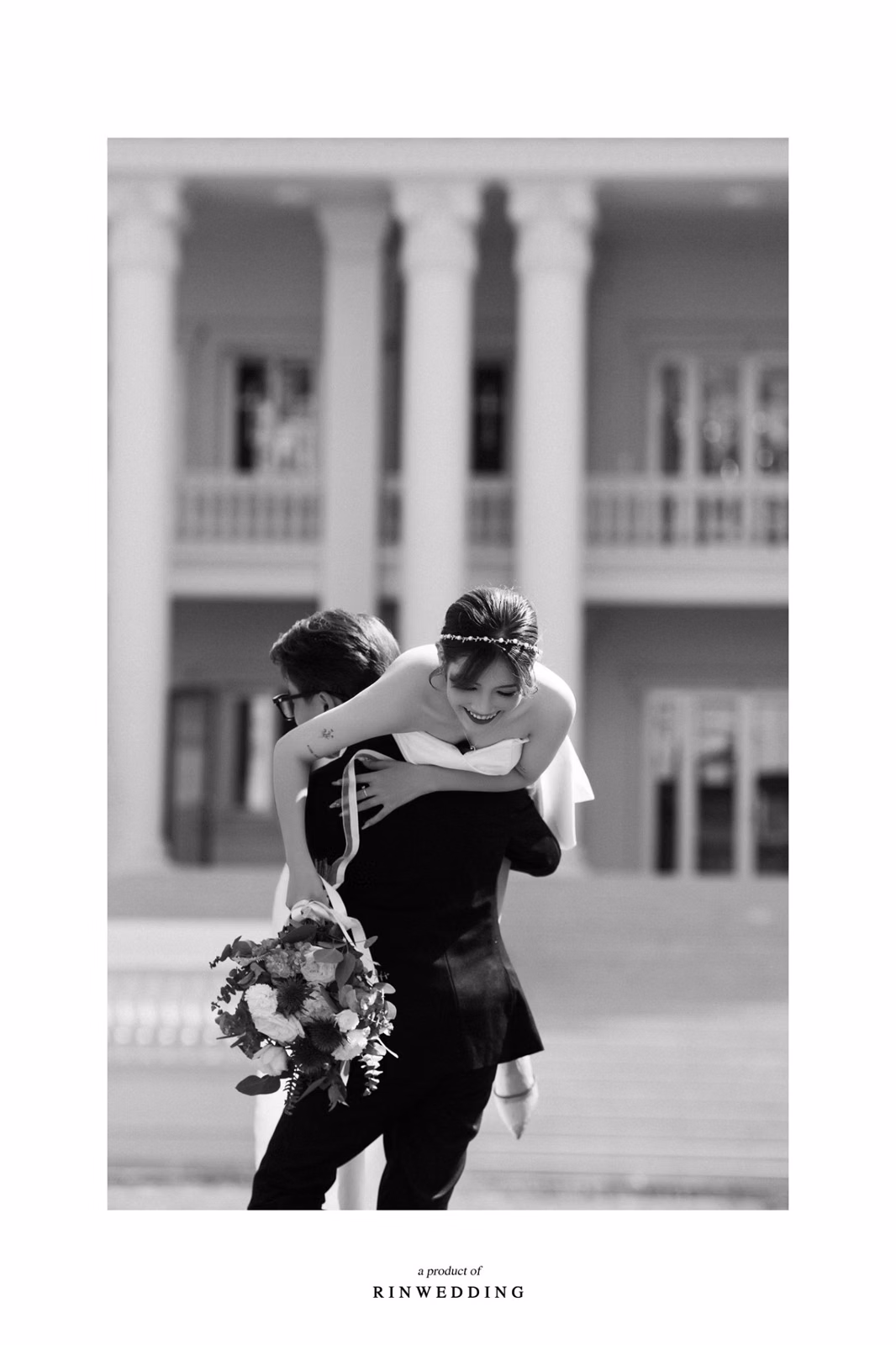 Black-and-white photograph of the bride and groom embracing at Nhà thờ Don Bosco