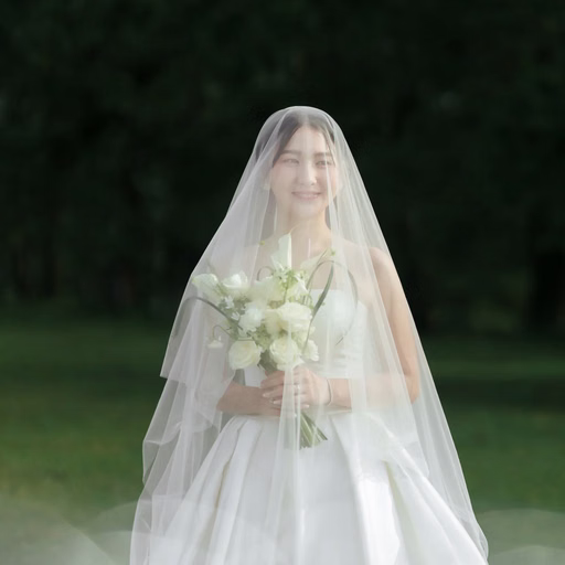 The veiled bride holding a white bouquet on the lawn at Cây Thông Cô Đơn, Da Lat