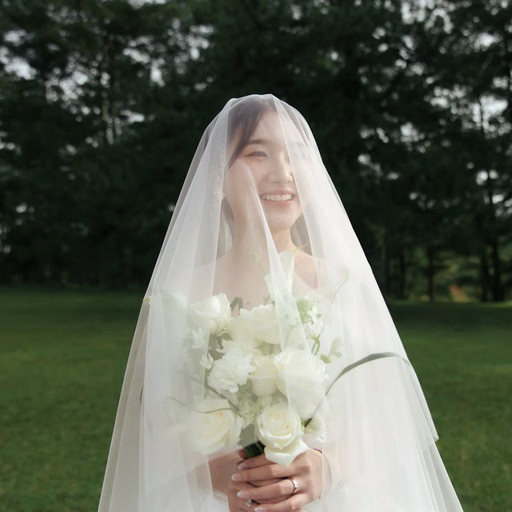 Portrait of the smiling bride beneath her veil with a white bouquet at Cây Thông Cô Đơn, Đà Lạt