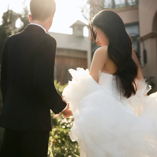 The bride looking back while holding the groom’s hand in the garden at The Nest, Da Lat