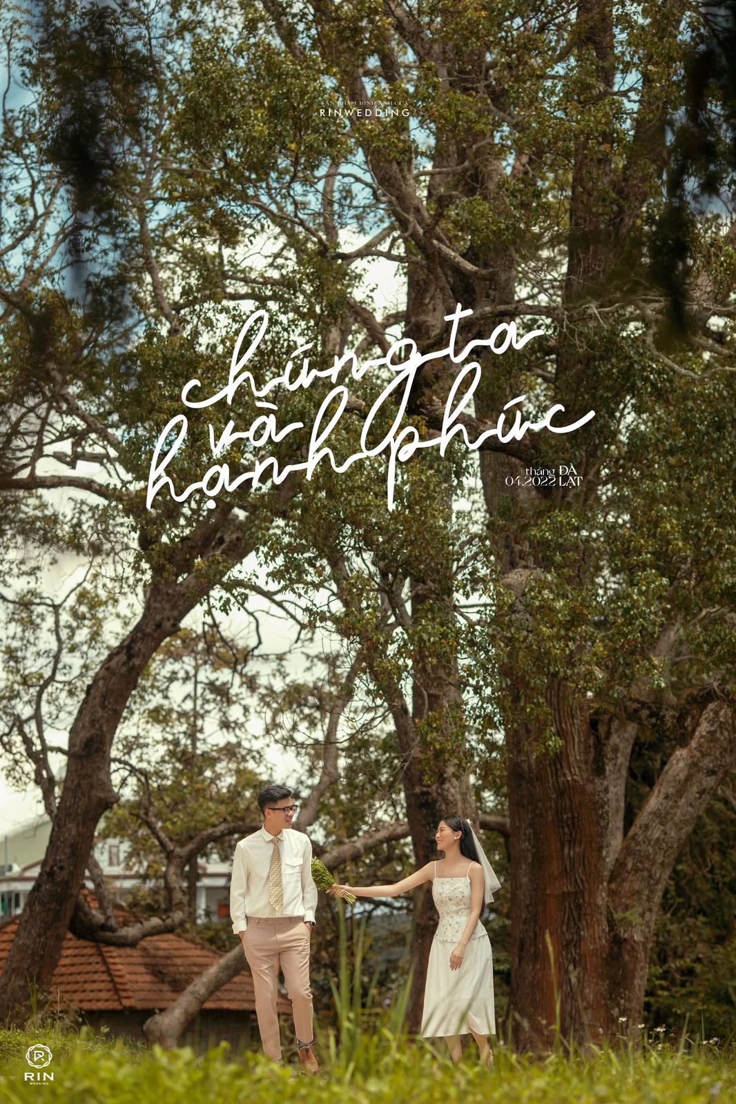 The couple hold hands beneath a large tree at Dinh Tỉnh Trưởng.