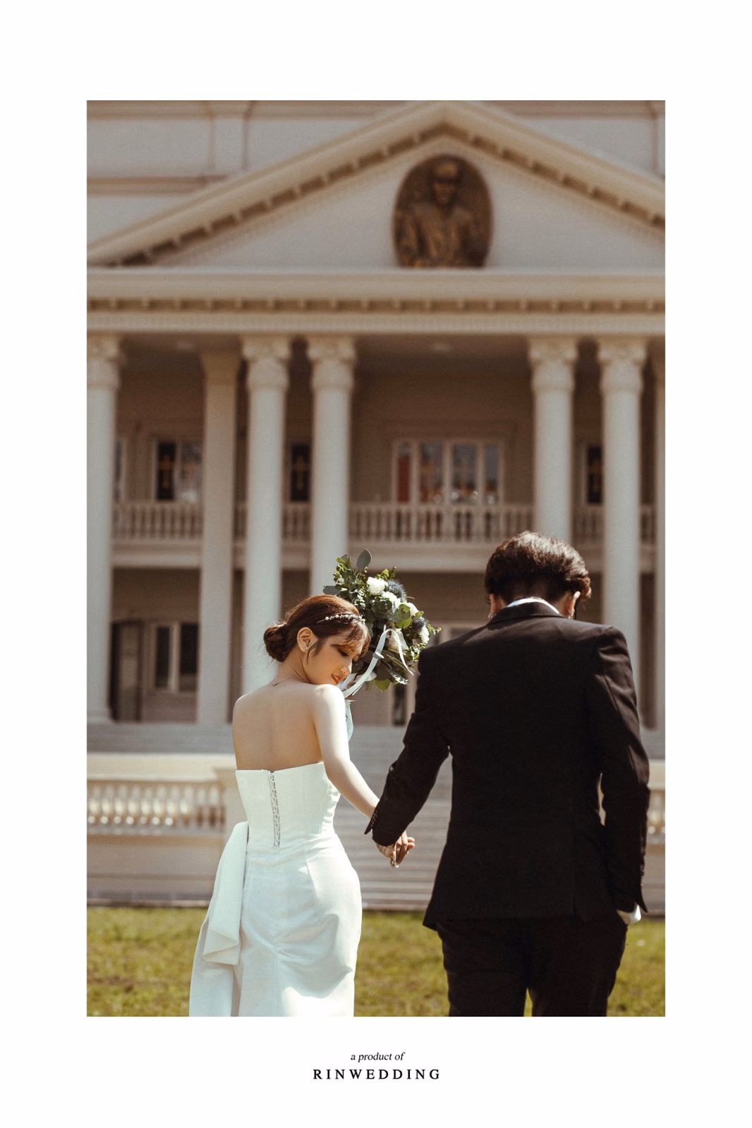 The bride and groom hold hands walking toward Nhà thờ Don Bosco