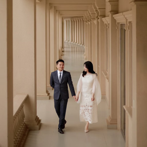 The bride and groom walking through a corridor at Nhà thờ Don Bosco