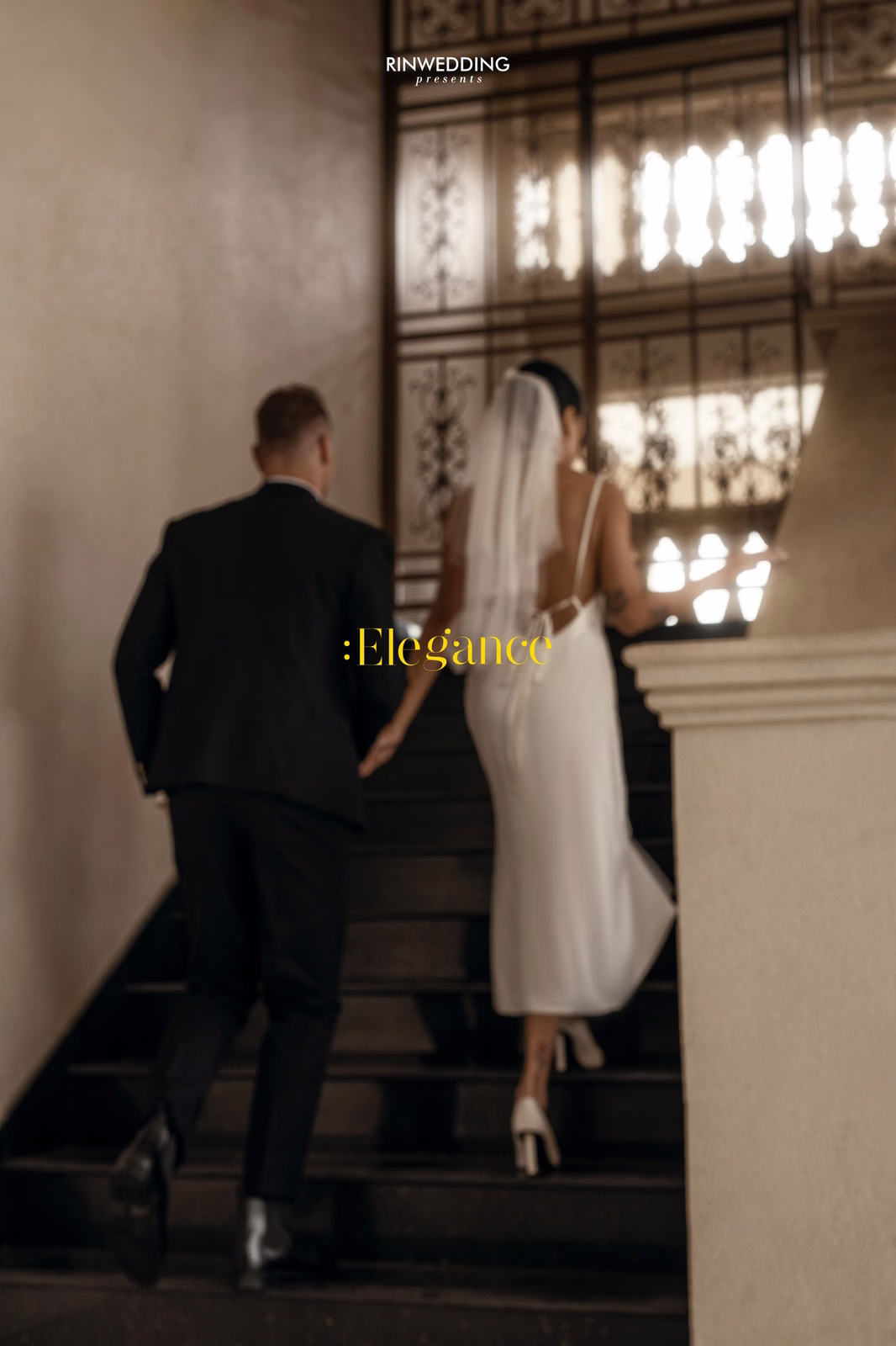 The bride and groom holding hands while ascending the Don Bosco steps.
