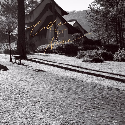 A pitched-roof villa and pine trees in a black-and-white wedding photograph.