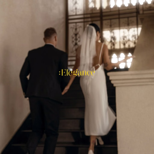 The bride and groom holding hands while ascending the Don Bosco steps.