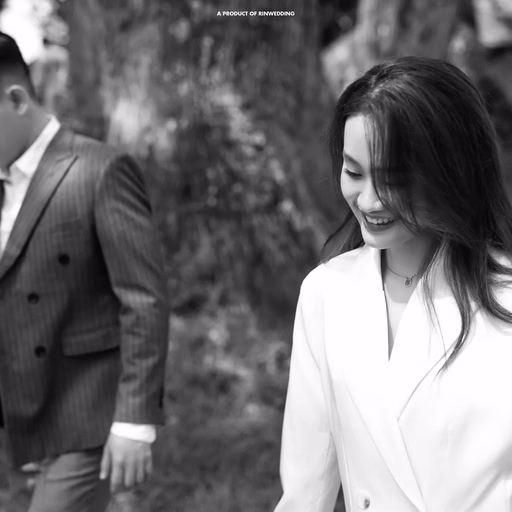 A black-and-white photograph of the couple holding hands in the garden of Dinh Tỉnh Trưởng.