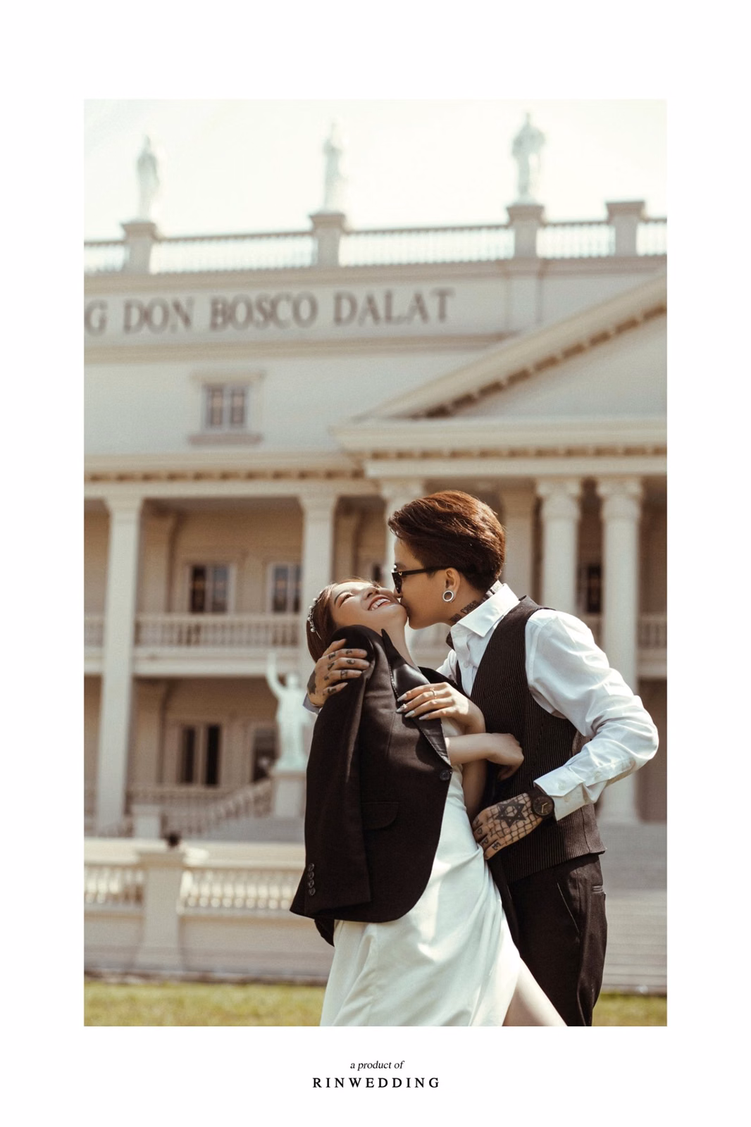 The groom kissing the bride’s hand before Nhà thờ Don Bosco