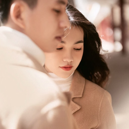 Close-up of a couple in brown-toned outfits at Ga Đà Lạt.